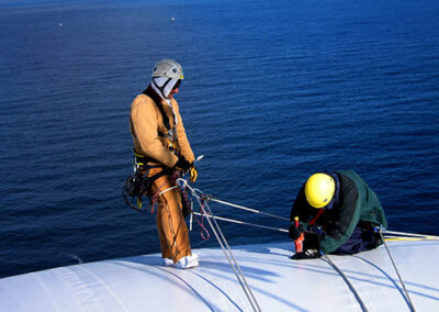 Technicians performs maintenance on air supported radome.